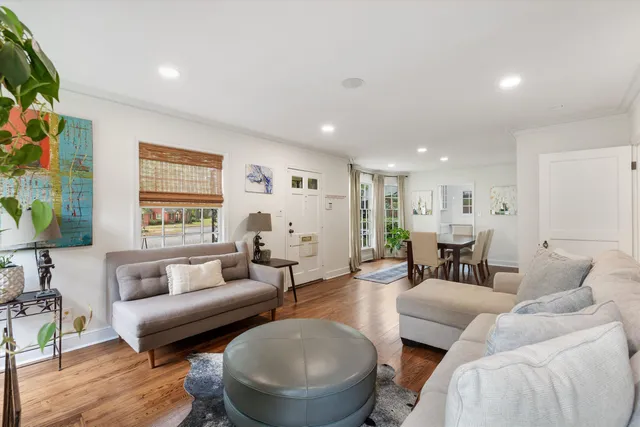 a living room with fireplace furniture and a large window