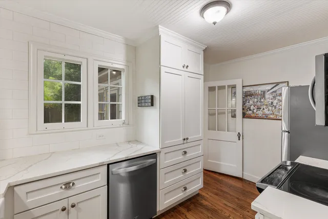 a kitchen with stainless steel appliances a stove microwave and refrigerator