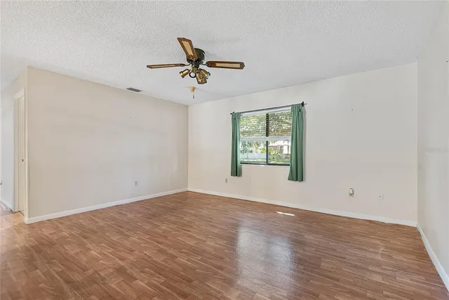 a kitchen with granite countertop a sink and white cabinets