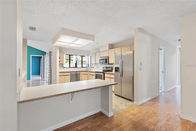 a kitchen with white cabinets a sink and dishwasher