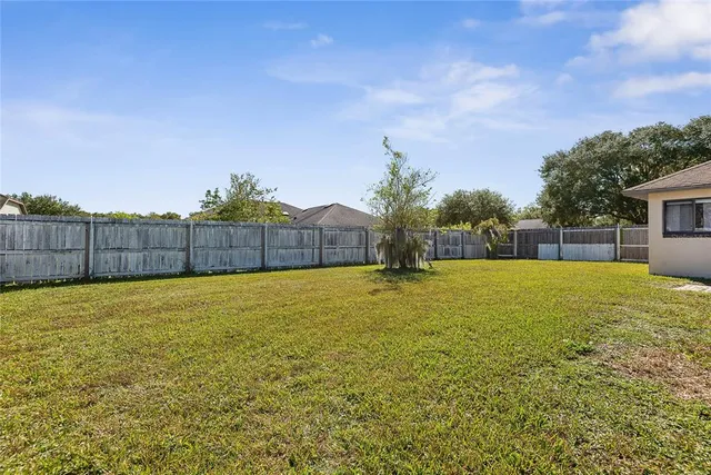 an aerial view of a house with yard swimming pool and outdoor seating