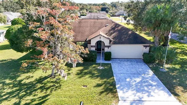 a view of a house with swimming pool and sitting area