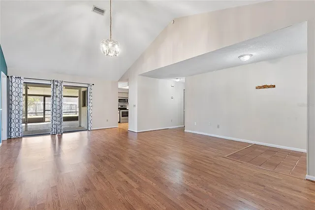 a view of a room with window wooden floor and windows