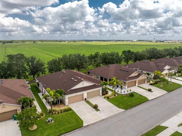 an aerial view of a house with garden space and ocean view