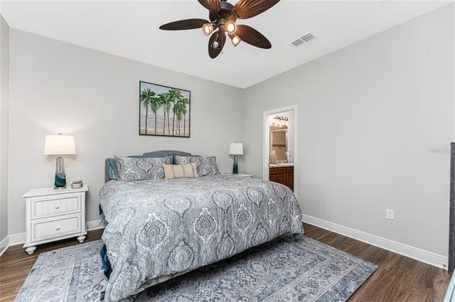 a bathroom with a granite countertop sink a toilet a mirror and shower