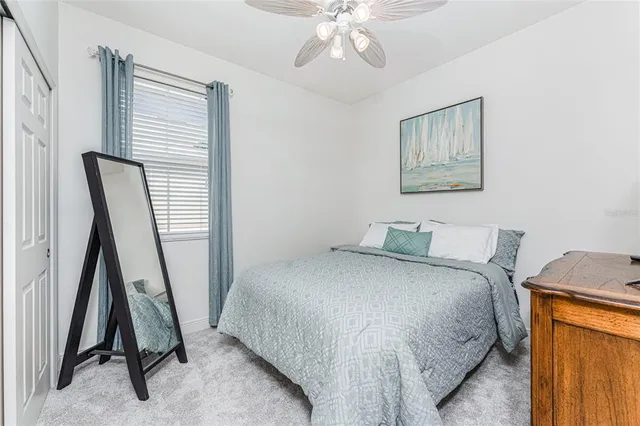 a bedroom with a bed and cabinets