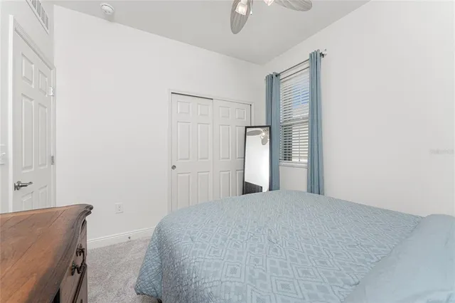 a bathroom with a toilet sink vanity and mirror