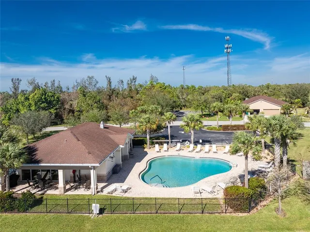 a view of a house with pool outdoor seating and yard