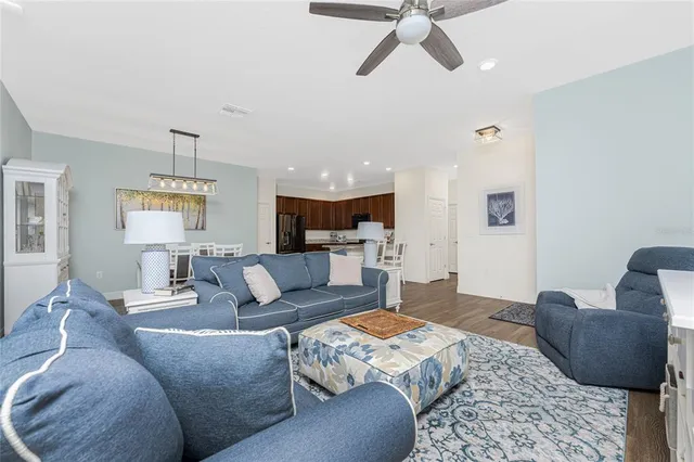 a living room with furniture and a ceiling fan