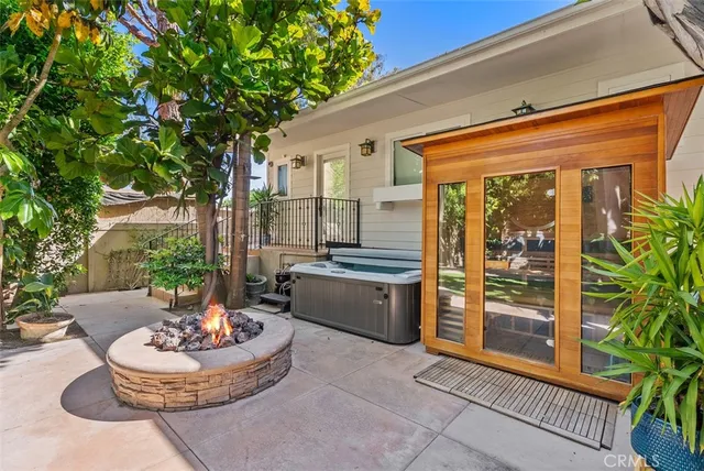a living room with patio furniture and a potted plant