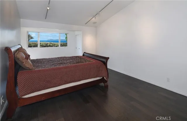 a bed sitting in a bedroom next to a window