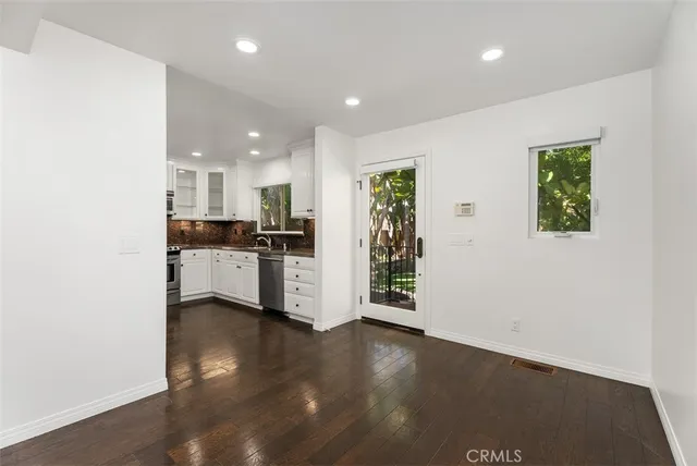 a view of kitchen with wooden floor and electronic appliances