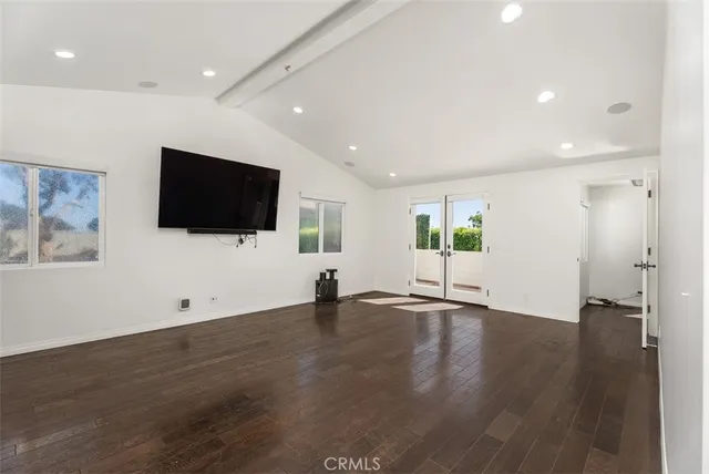 a view of a livingroom with wooden floor and flat screen tv