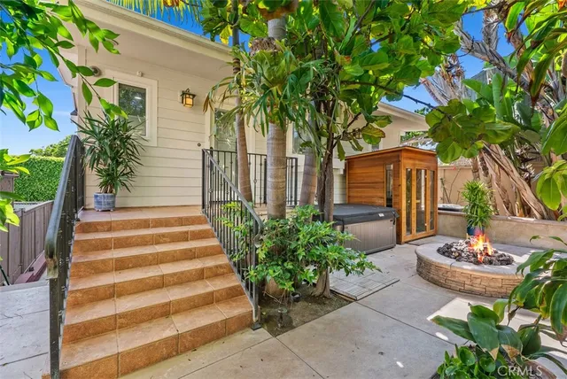 a view of a house with a yard and sitting area