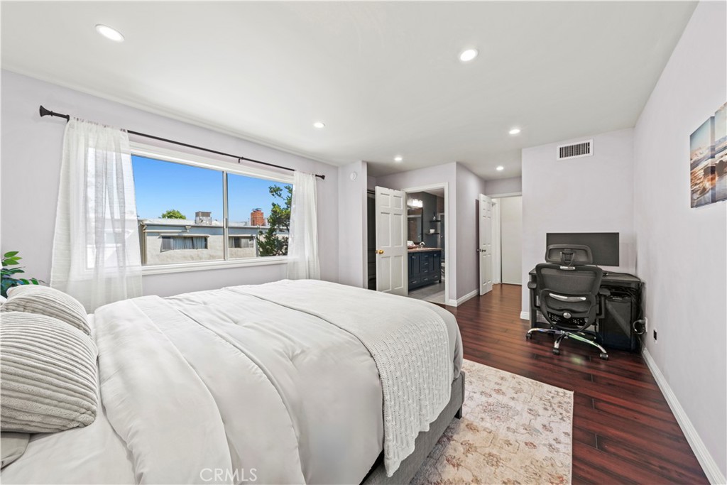 5215 Balboa Boulevard, Unit 203 Encino, CA 91316 - Photo 11 of 27 a bedroom with a bed and a chair