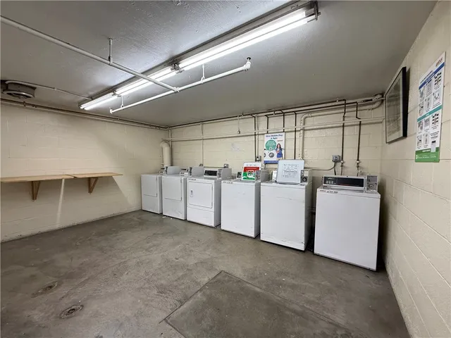 a room with cabinets and white appliances