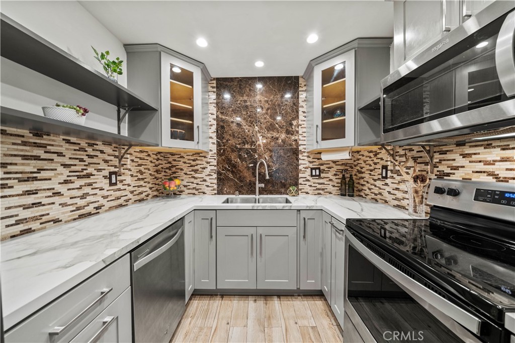 5215 Balboa Boulevard, Unit 203 Encino, CA 91316 - Photo 7 of 27 a kitchen with stainless steel appliances granite countertop a sink and cabinets