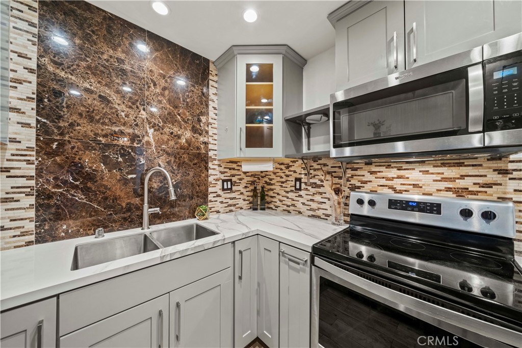 5215 Balboa Boulevard, Unit 203 Encino, CA 91316 - Photo 8 of 27 a kitchen with granite countertop a stove and a sink