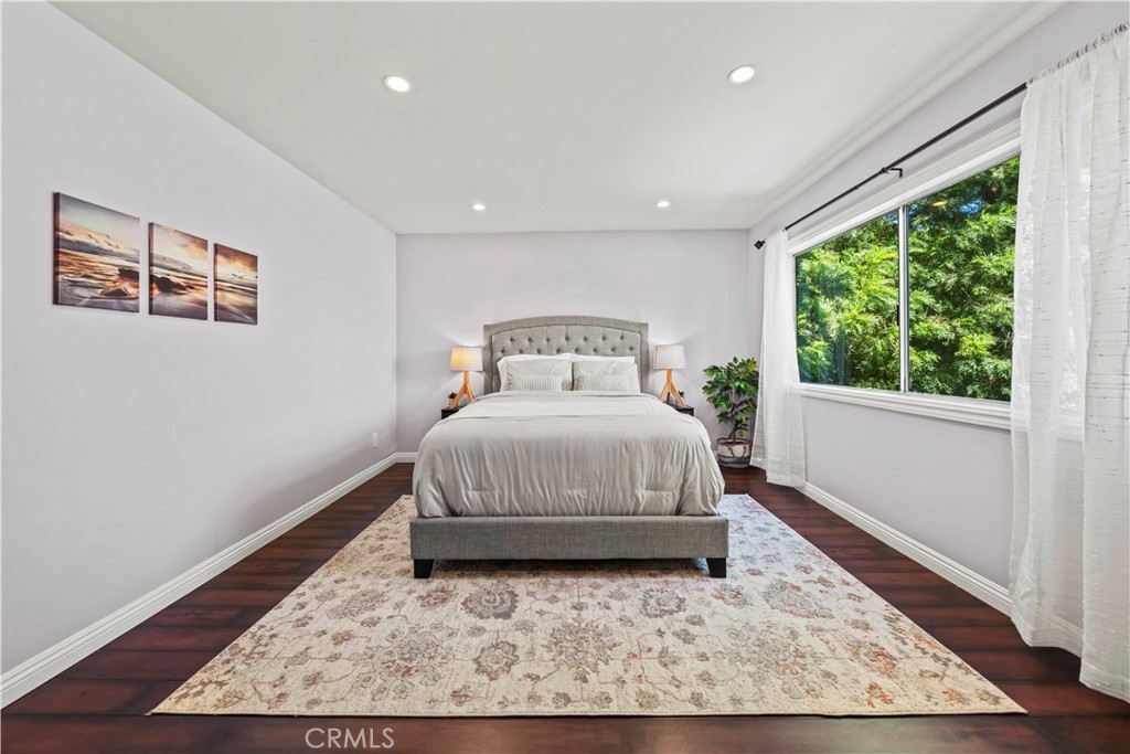 5215 Balboa Boulevard, Unit 203 Encino, CA 91316 - Photo 10 of 27 a bedroom with a bed and wooden floor