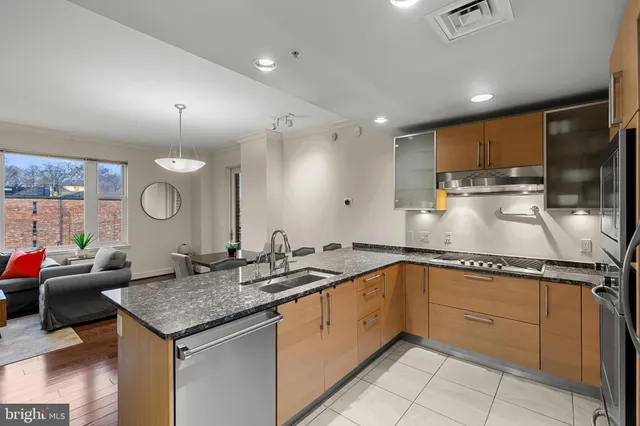 a kitchen with a sink stainless steel appliances and cabinets