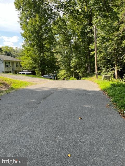 8202 Sycamore Road Lusby, MD 20657 - Photo 8 of 8 a view of a house with pool and a yard