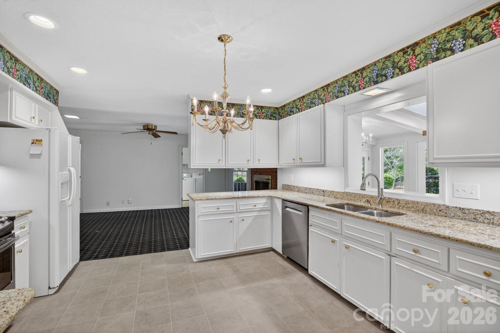 236 Richmond Road Salisbury, NC 28144 - Photo 18 of 48 a large kitchen with kitchen island white cabinets and chandelier