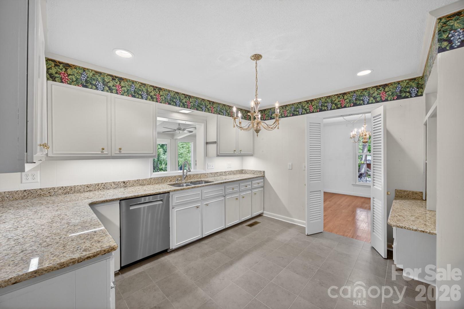 236 Richmond Road Salisbury, NC 28144 - Photo 6 of 48 a large kitchen with granite countertop a sink and dishwasher a stove top oven with wooden floor