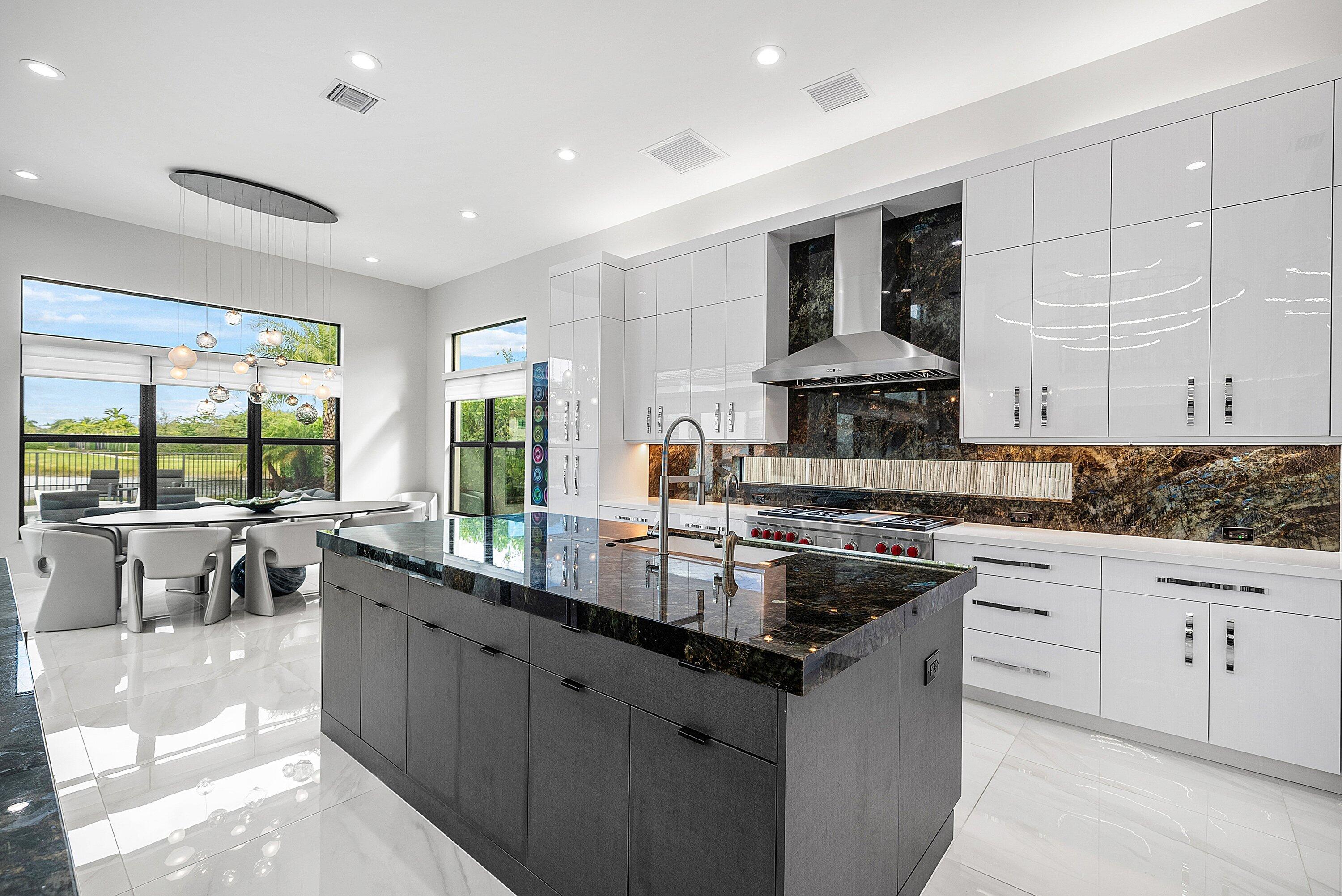 9569 Vescovato Way Boca Raton, FL 33496 - Photo 14 of 98 a kitchen with stainless steel appliances granite countertop a sink stove and cabinets