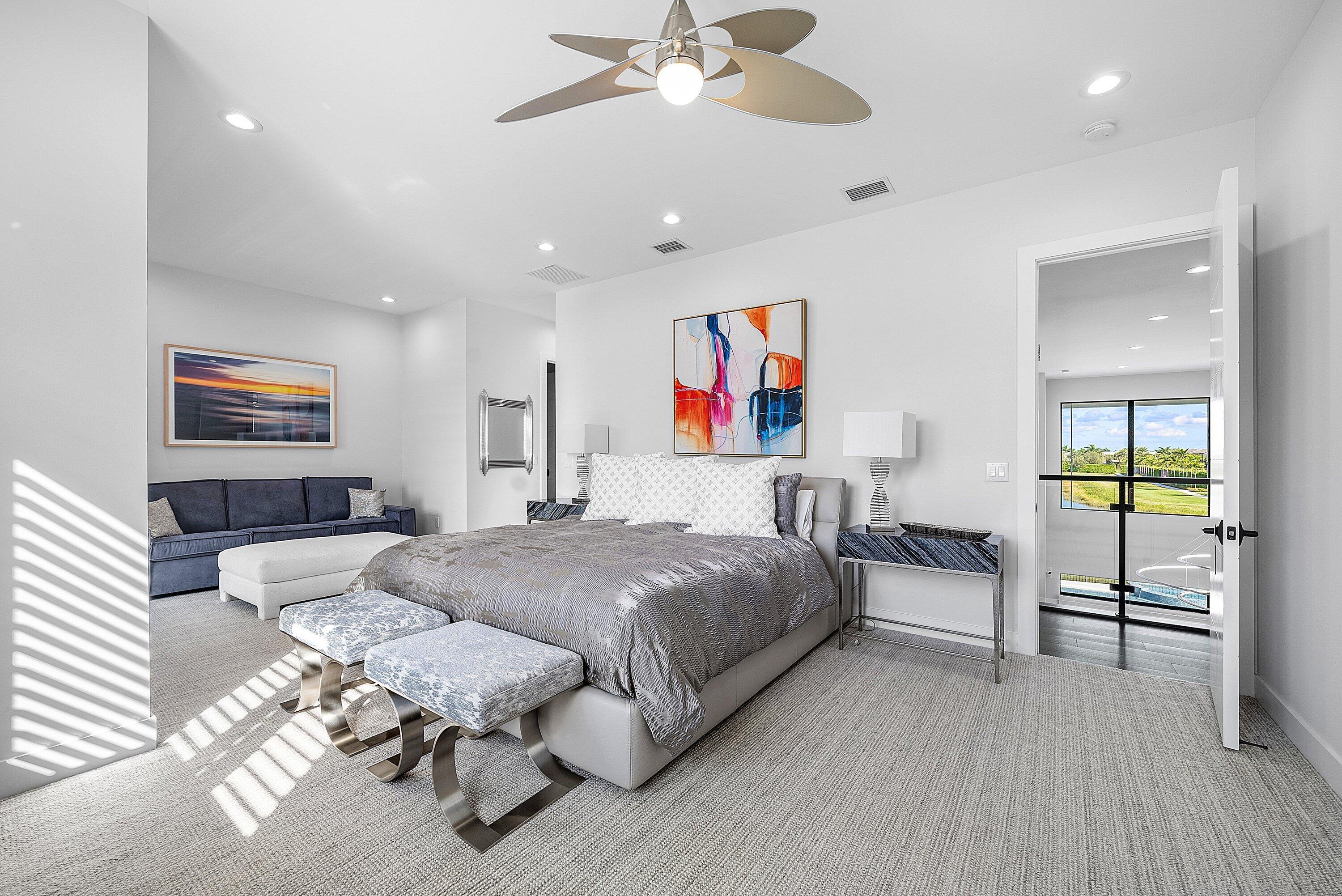9569 Vescovato Way Boca Raton, FL 33496 - Photo 28 of 98 a spacious bedroom with a bed painting on wall and a large window