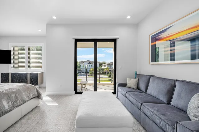 a bathroom with a granite countertop sink a mirror a toilet and a shower