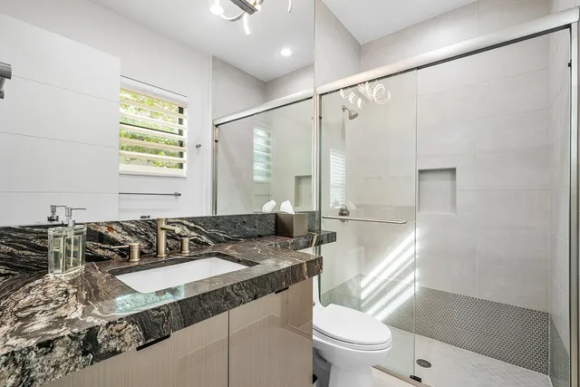 a backyard of a house with outdoor seating and a garden