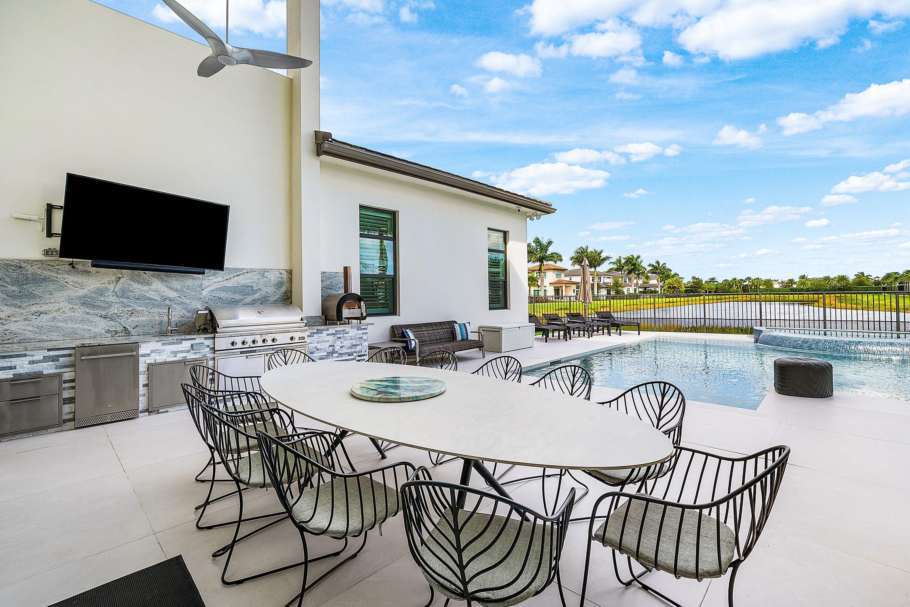 9569 Vescovato Way Boca Raton, FL 33496 - Photo 46 of 98 a view of a patio with a dining table and chairs with wooden floor