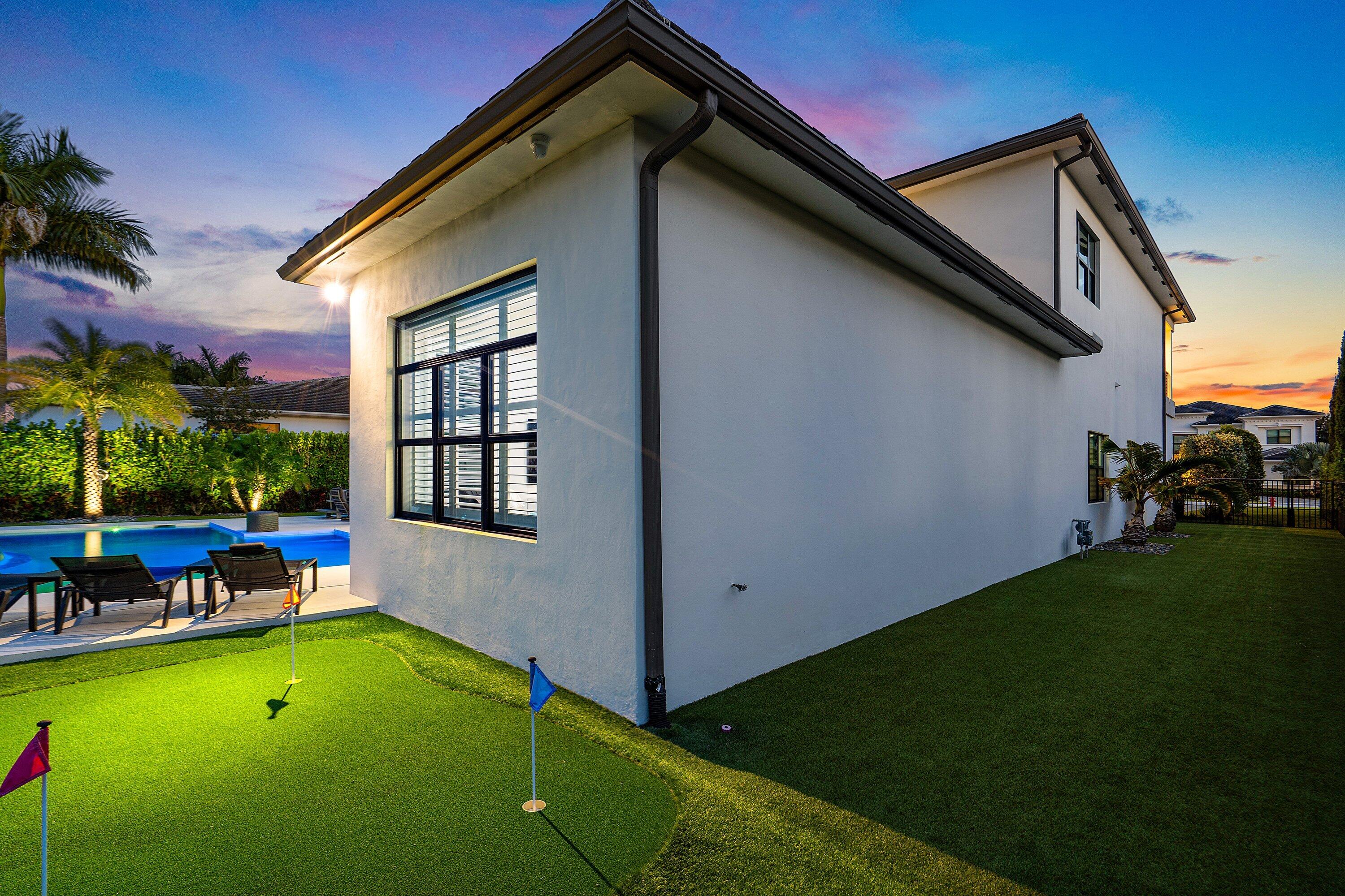 9569 Vescovato Way Boca Raton, FL 33496 - Photo 67 of 98 a backyard of a house with outdoor seating and a garden