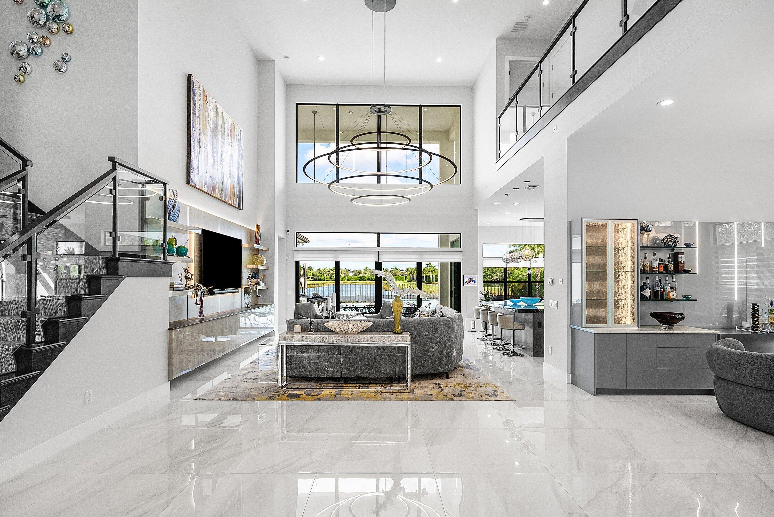 9569 Vescovato Way Boca Raton, FL 33496 - Photo 7 of 98 a living room with furniture large window and flat screen tv