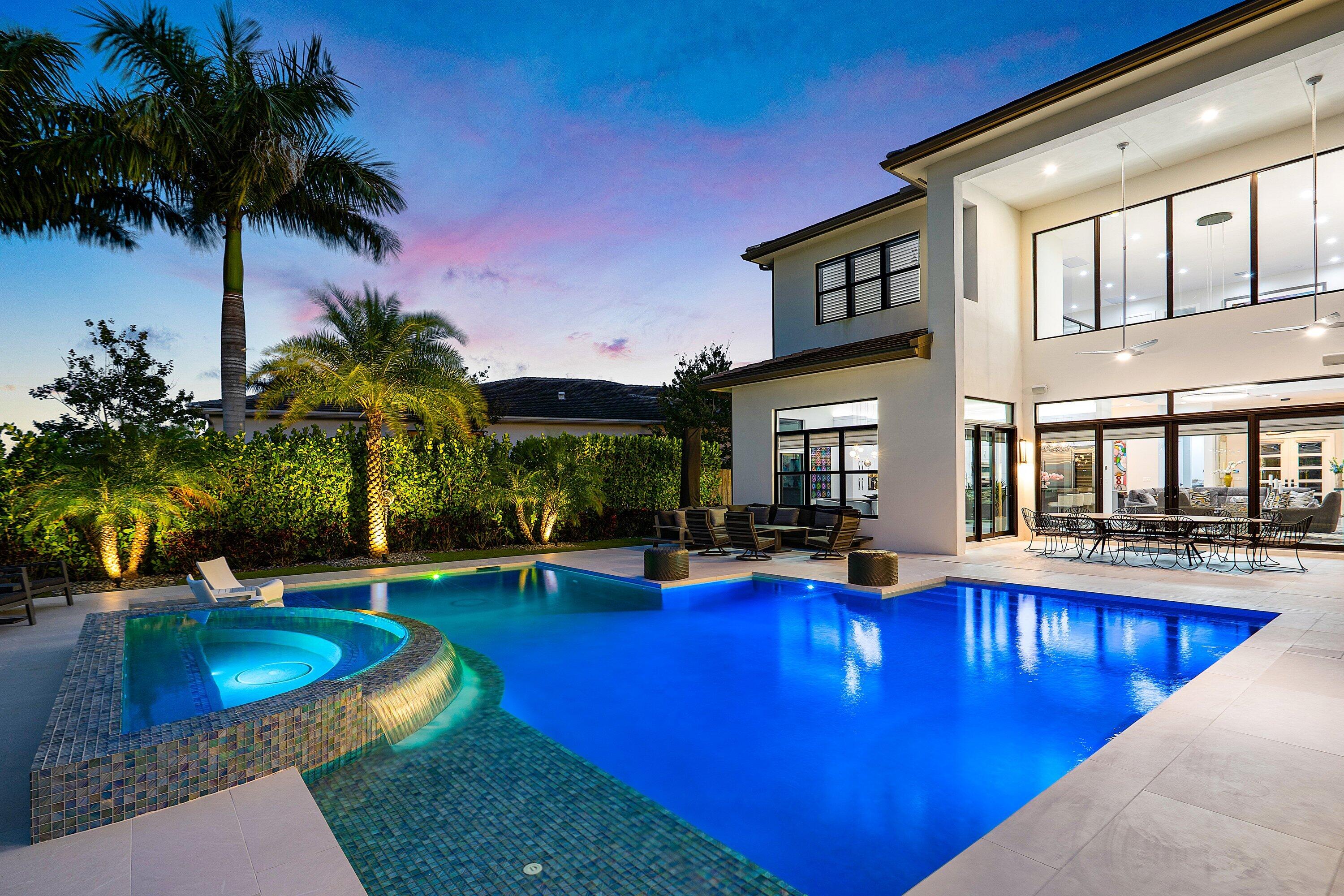 9569 Vescovato Way Boca Raton, FL 33496 - Photo 71 of 98 a view of a swimming pool with chairs and table in the patio