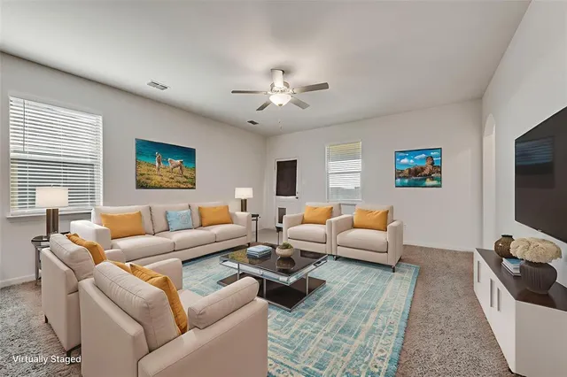 a living room with furniture and a flat screen tv