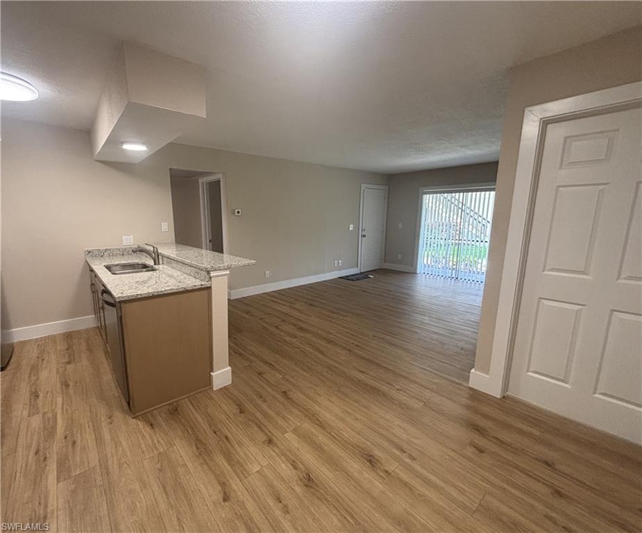 5305 Summerlin Road, Unit 501 Fort Myers, FL 33919 - Photo 2 of 10 an empty room with wooden floor dryer and washer