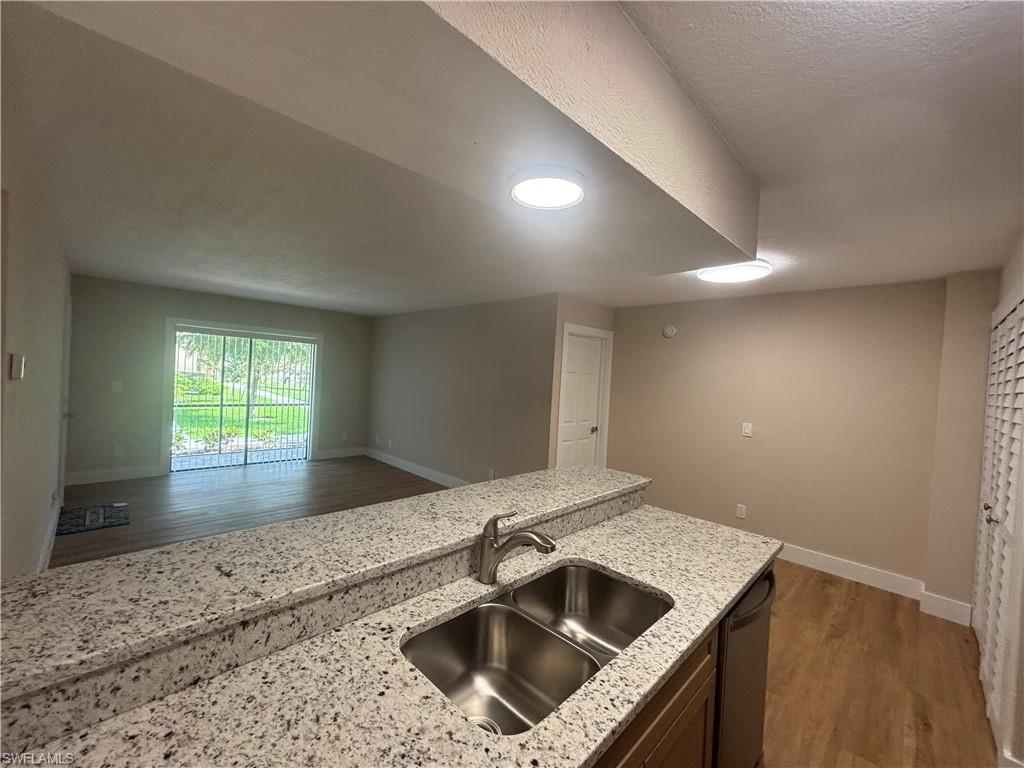 5305 Summerlin Road, Unit 501 Fort Myers, FL 33919 - Photo 3 of 10 a kitchen with a sink and a window