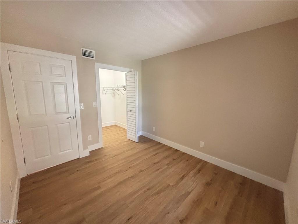 5305 Summerlin Road, Unit 501 Fort Myers, FL 33919 - Photo 7 of 10 wooden floor in an empty room