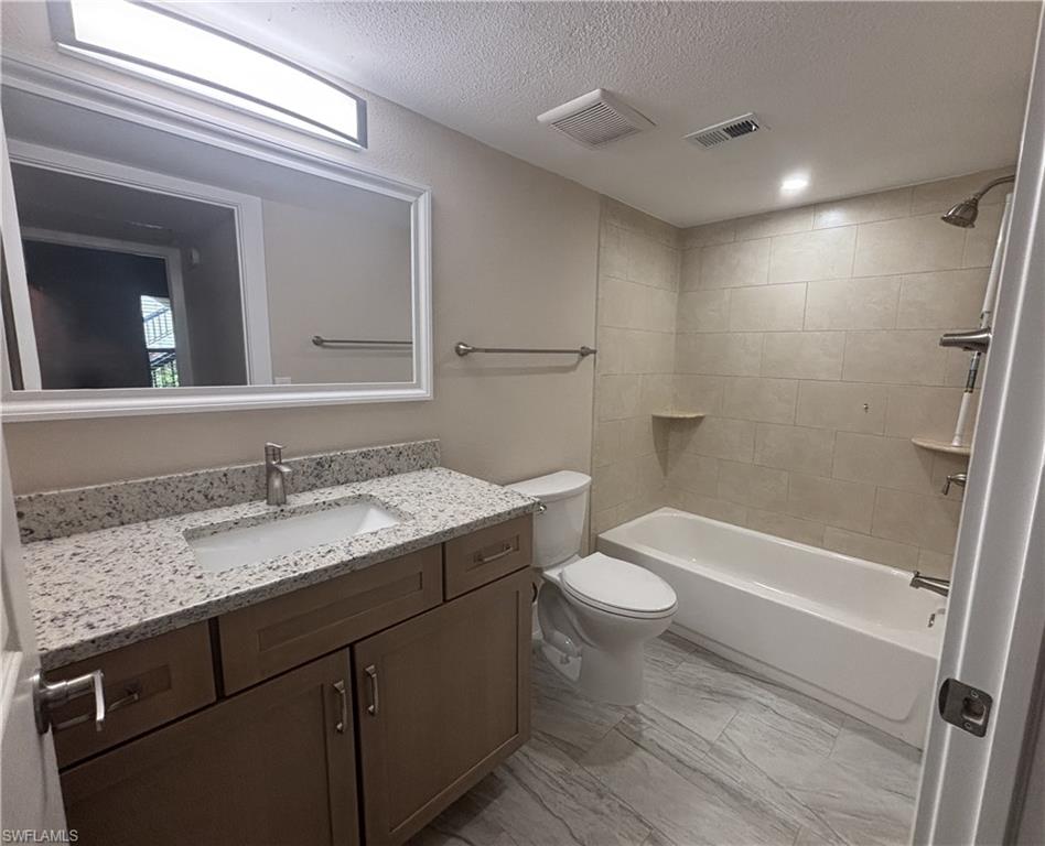 5305 Summerlin Road, Unit 501 Fort Myers, FL 33919 - Photo 9 of 10 a bathroom with a granite countertop sink toilet and shower