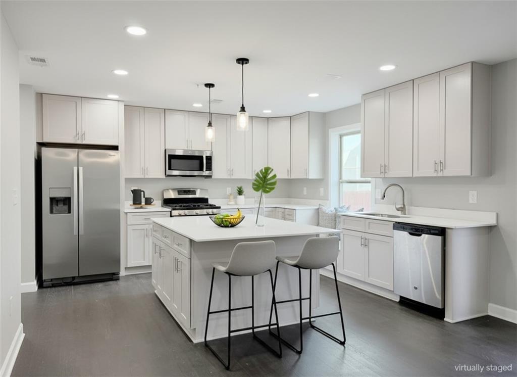 615 Ceremony Way Acworth, GA 30102 - Photo 8 of 9 a kitchen with stainless steel appliances granite countertop a white cabinets and a refrigerator