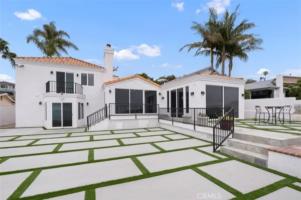 a large kitchen with stainless steel appliances granite countertop a large counter top a stove and a sink