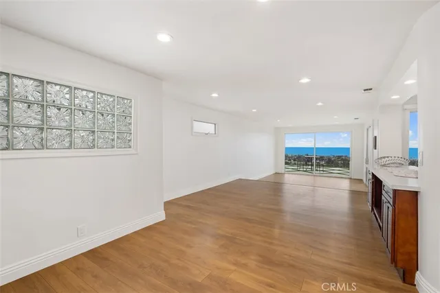 a large kitchen with stainless steel appliances granite countertop a large counter top a stove and a sink