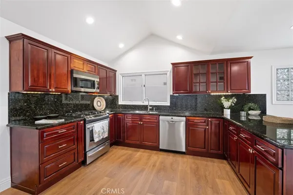a view of an empty room with a window and bathroom