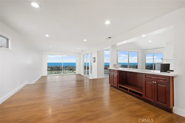 a view of an empty room with a window and bathroom