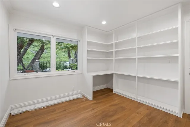 a view of an empty room with glass door and balcony