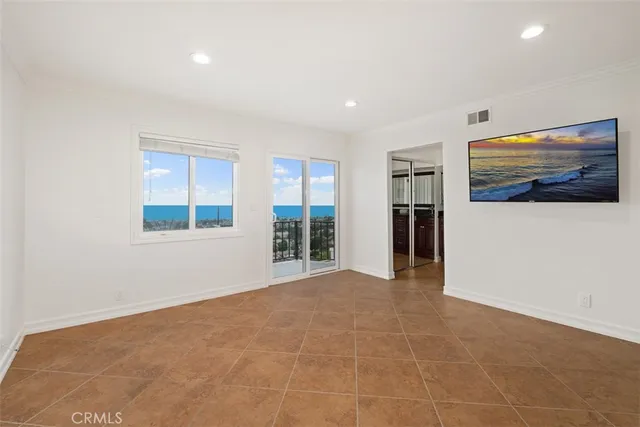 an empty room with wooden floor and a window