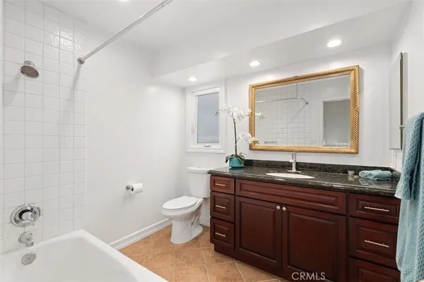 a view of empty room with wooden floor and fireplace