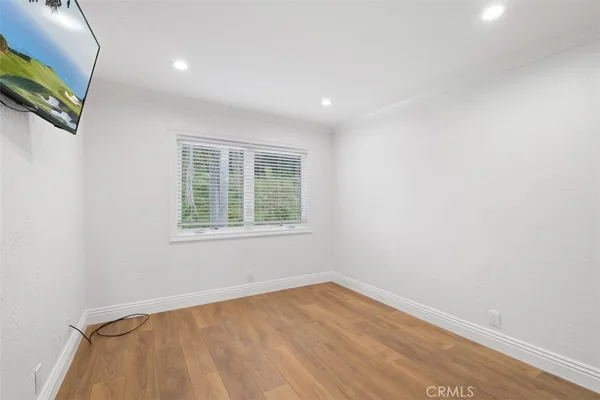 an empty room with floor to ceiling window and fireplace