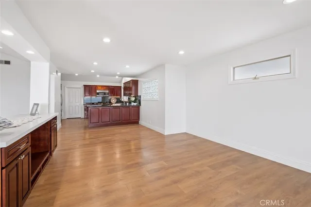 a large kitchen with stainless steel appliances granite countertop a sink and cabinets